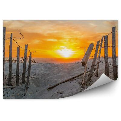 Öntapadós fotótapéta falra Kerítés kövek strand naplemente égbolt