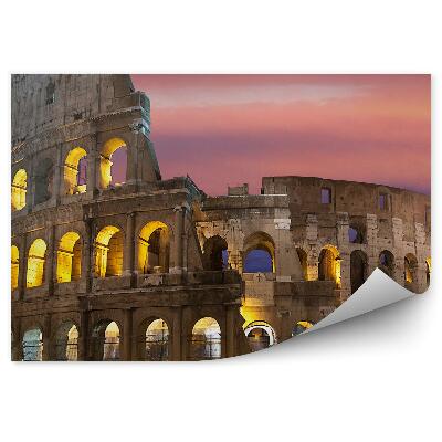 Fotótapéta A megvilágított Colosseum a háttérben a színes égbolt
