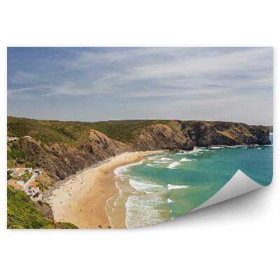 Öntapadó fotótapéta Csodálatos arrifana tengerparti épületek fák sziklák az óceán hullámait