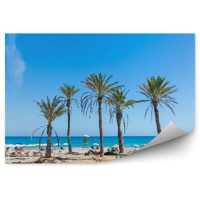 Öntapadós fotótapéta falra Gyaloghíd pálmafák emberek nyugágyak esernyők óceán ég
