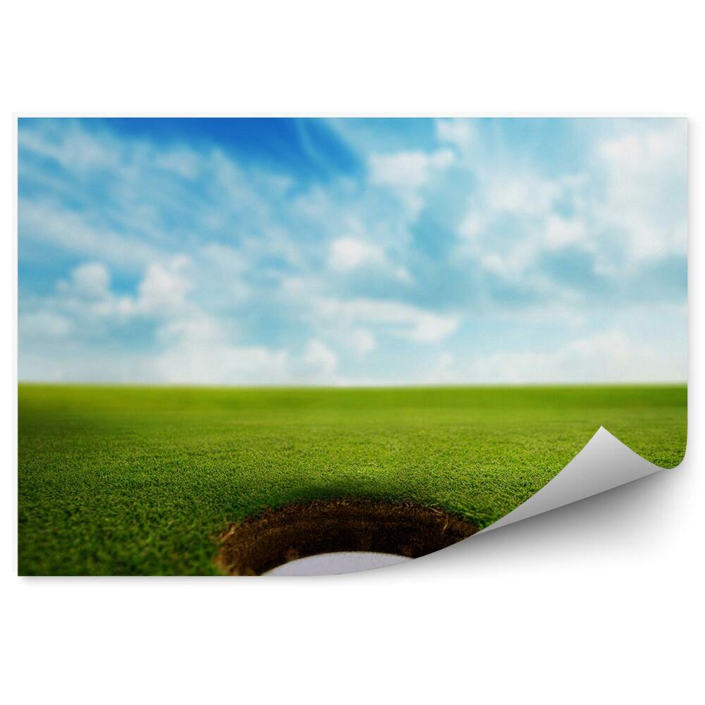Fotótapéta Golf labda le fűben ég felhők
