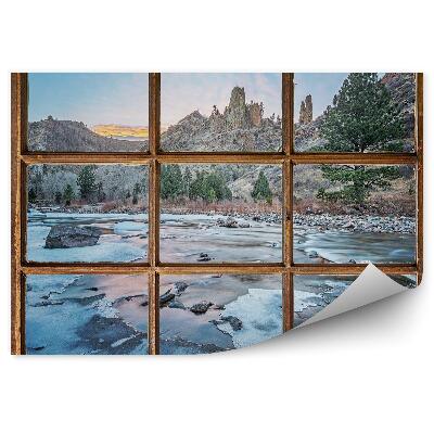 Fotótapéta Régi ablak kilátással a hegyekre és a befagyott patakra