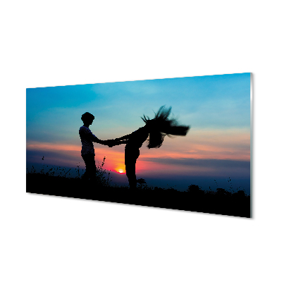 Emberek naplemente ég a réten Üvegkép