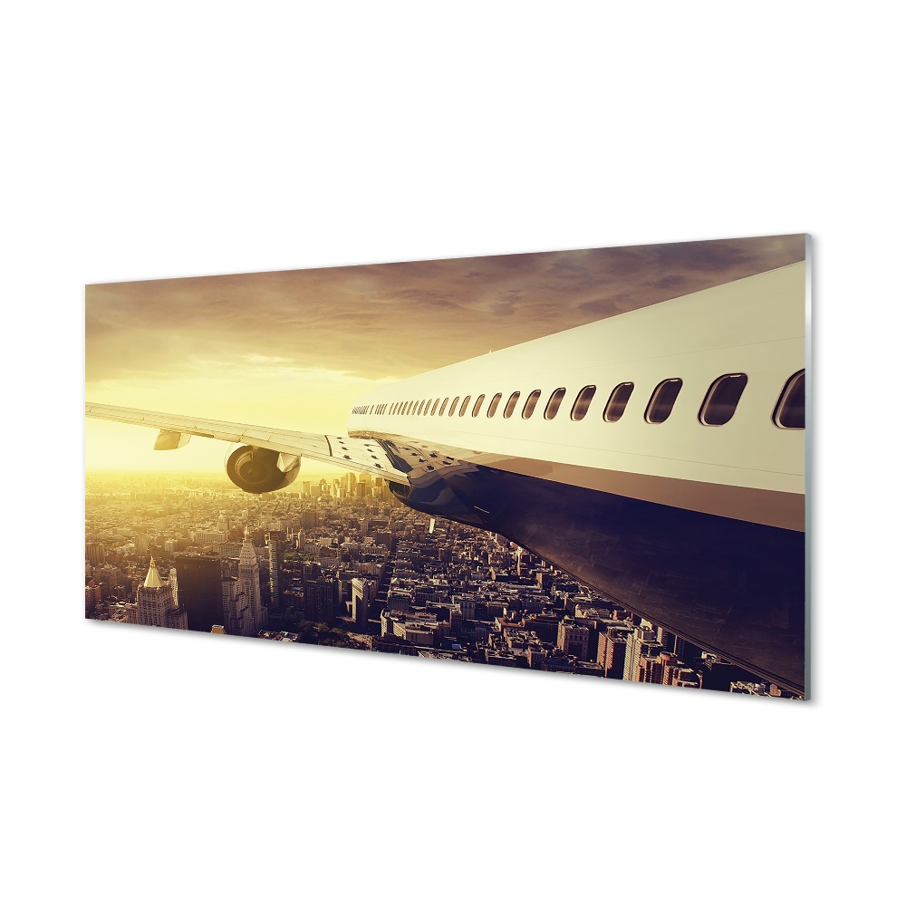 Repülőgép a város épületei felett Üvegkép