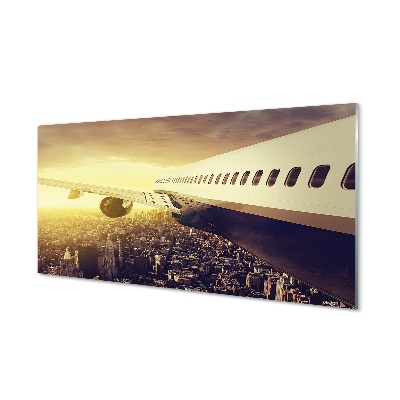 Repülőgép a város épületei felett Üvegkép