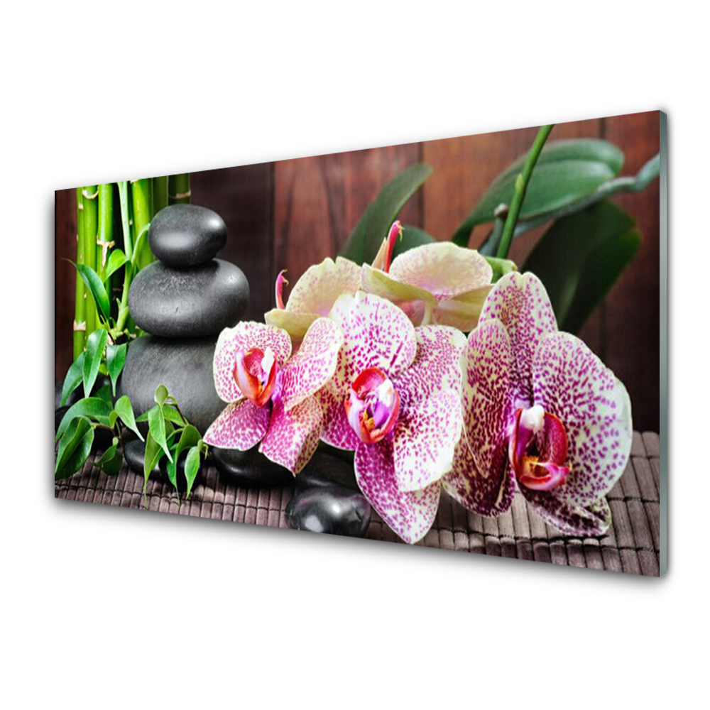 Üvegfotó Orchidea és kövek a szőnyegen