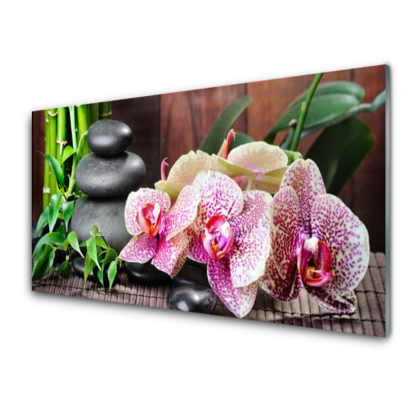 Üvegfotó Orchidea és kövek a szőnyegen